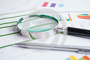 Magnifying glass on charts graphs paper. Financial development, Banking Account, Statistics, Investment Analytic research data