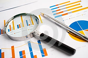 Magnifying glass on charts graphs paper. Financial development, Banking Account, Statistics, Investment Analytic research data