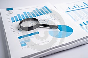Magnifying glass on charts graphs paper. Financial development, Banking Account, Statistics, Investment Analytic research data