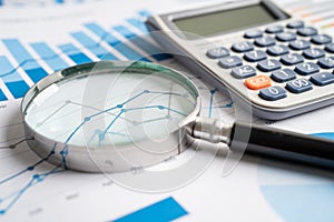 Magnifying glass on charts graphs paper. Financial development, Banking Account, Statistics, Investment Analytic research data