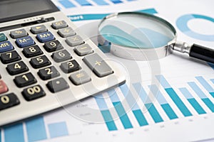 Magnifying glass on charts graphs paper. Financial development, Banking Account, Statistics, Investment Analytic research data