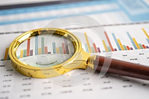 Magnifying glass on charts graphs paper. Financial development, Banking Account, Statistics, Investment Analytic research data