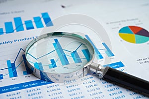 Magnifying glass on charts graphs paper. Financial development, Banking Account, Statistics, Investment Analytic research data