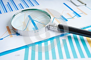 Magnifying glass on charts graphs paper. Financial development, Banking Account, Statistics, Investment Analytic research data