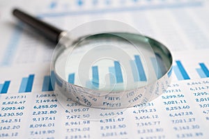 Magnifying glass on charts graphs paper. Financial development, Banking Account, Statistics, Investment Analytic research data