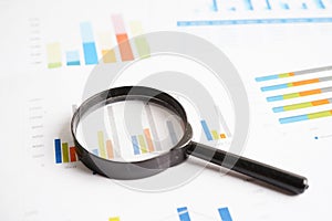 Magnifying glass on charts graphs paper. Financial development, Banking Account, Statistics, Investment Analytic research data