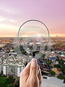 Magnifying glass and cityscape in focus