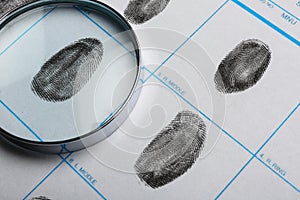 Magnifying glass and criminal fingerprint card