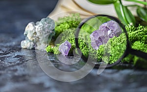 Magnifying glass and crystalline minerals for meditation, moss, book. Magic Rock for Healing stones. Minerals for relaxation,