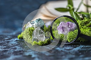 Magnifying glass and crystalline minerals for meditation, moss, book. Magic Rock for Healing stones. Minerals for relaxation,
