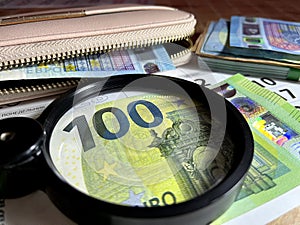 Magnifying glass on different Euro banknotes