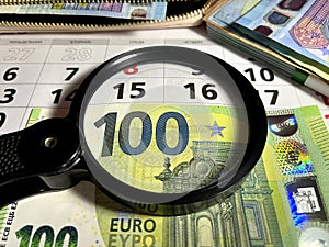 Magnifying glass on different Euro banknotes