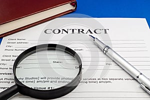 Magnifying glass and document contract close up