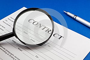 Magnifying glass and document contract close up
