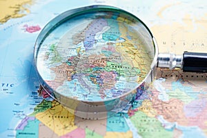 Magnifying glass on europe world globe map photo