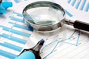 Magnifying glass and financial documents. Audit and accounting photo