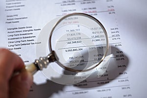 Magnifying glass on financial report