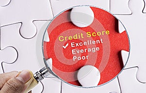 Magnifying glass focus on Excellent credit score evaluation form.