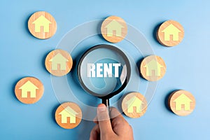 Magnifying glass focus rent word. The concept of renting housing and real estate. The cost of a rented home or apartment