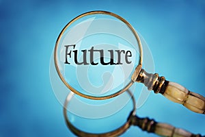 Magnifying glass focus on the word future photo
