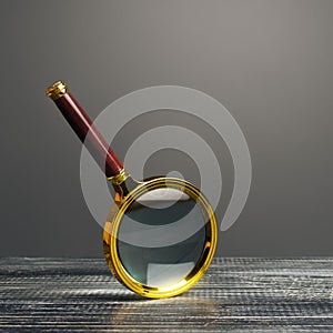 Magnifying glass on a gray background. Search and analysis, analytics and study. Find something. Journalistic investigations