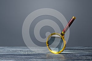 Magnifying glass on a gray background. Search and analysis, analytics and study. Pay attention to details and problems. Find