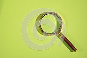 Magnifying glass on the green background