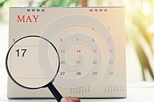 Magnifying glass in hand on calendar you can look seventeenth da