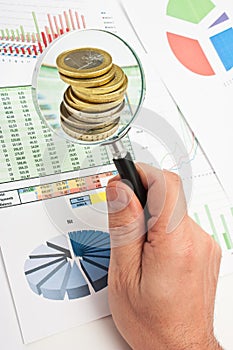 Magnifying glass in hand and paper