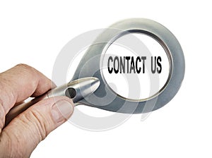 Magnifying glass in the hand on the white. Concact us concept