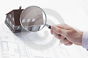 Magnifying glass and house.