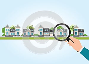 Magnifying glass in human hand with house icon.