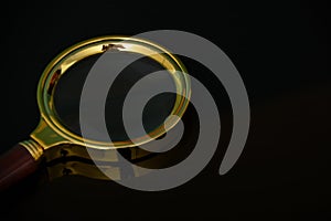 Magnifying glass isolated on a black background. Copy space
