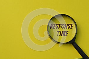 Magnifying glass isolated on a yellow background with text RESPONSE TIME