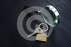 Magnifying glass and key for home. Property appraisal concept.