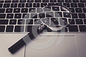 Magnifying Glass With Laptop Background