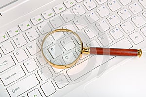Magnifying glass on laptop c