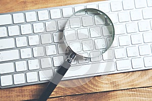 Magnifying glass on laptop computer