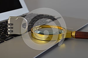 Magnifying glass, laptop and padlock. Login and password, cybersecurity, data protection and secured internet access concept