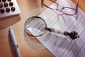 Magnifying glass on a legal contract