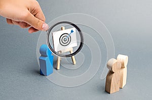 Magnifying glass is looking at leader explains employee tactics of advertising targeting. Training, briefing. Search strategies