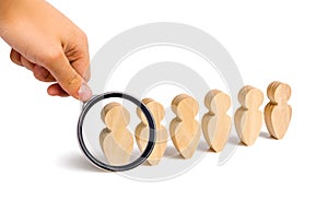 Magnifying glass is looking at the People stand in a formation on a white background. Discipline and order, submission.