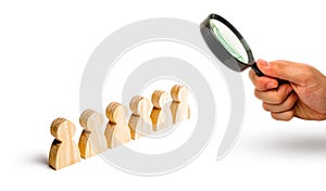 Magnifying glass is looking at the People stand in a formation on a white background. Discipline and order, submission.