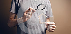 magnifying glass looks at the house. real estate search