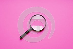 Magnifying glass magnifier loupe search symbol on pink background