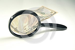 Magnifying glass and money