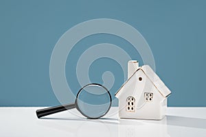 Magnifying glass mortgage calculator or real estate business concept