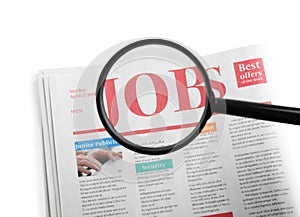 Magnifying glass and newspaper with headline JOBS on white background