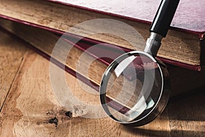 Magnifying glass and old book