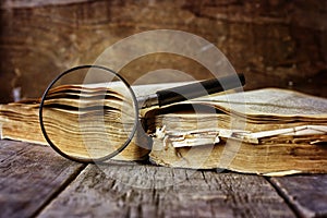 Magnifying glass and old book